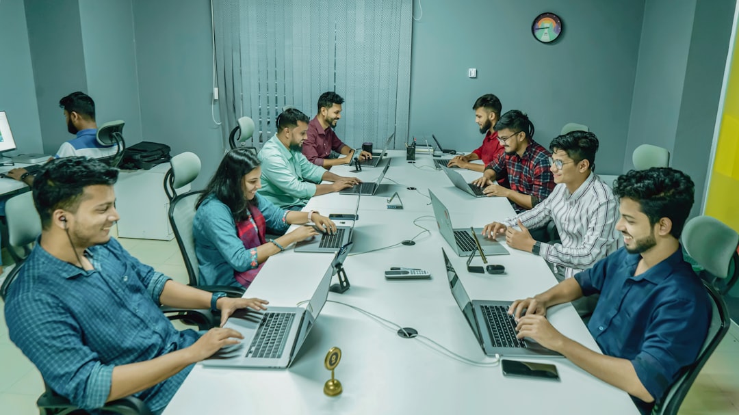 Startup team using all-in-one business software dashboard on multiple screens