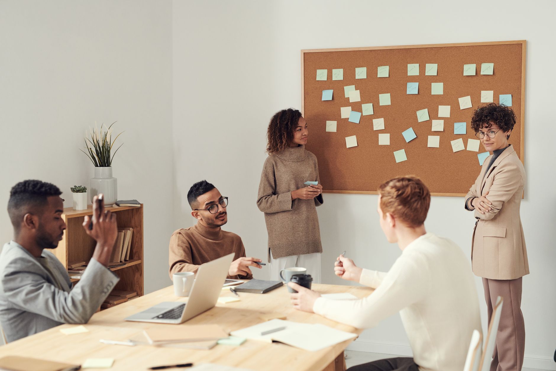 Small team reviewing an AI-generated meeting summary on a laptop screen