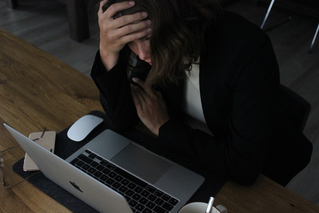 Freelancer reviewing a client workload audit spreadsheet on a laptop